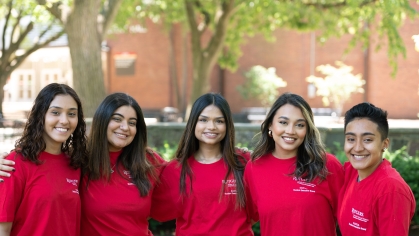 A group of EOF scholars in red shirts pose for a picture