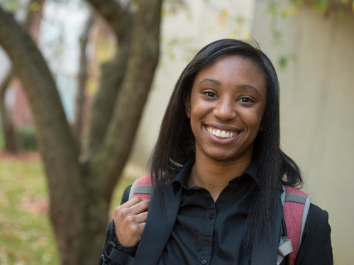 Black young student portrait with a backpack